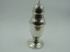A silver sugar caster of urn form having push on pierced lid and weighted pedestal base,