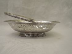 A Georgian silver sweetmeat basket of boat form having pierced and bright cut decoration, beaded
