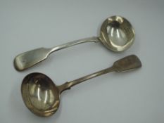 A pair of Georgian silver sauce ladles of fiddle back form bearing monogram to terminals, London