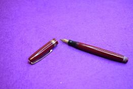A Mabie Todd & Co Swan Leverless twist filler, in maroon with two narrow and one broad band to cap