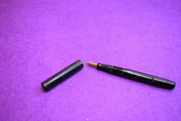 A Mabie Todd Swan Self-filler leverfill fountain pen in black with chaised design, clip less
