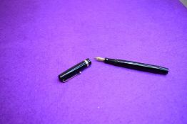 A Mabie Todd & Co Swan Self filler leverfill in black having a single gold band to cap with Swan No2