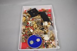 A box containing a selection of costume jewellery earrings and cufflinks etc