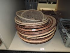 Sixteen round, shallow baskets.