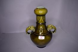 A majolica sarreguemines vase having gargoyle handles in green glaze