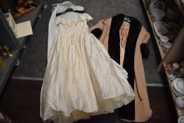 A ladies evening gown or dress by Ronald Joyce London and an over coat by J Taylor