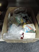 A box full of mixed vintage haberdashery including buttons, thread, press studs and similar.