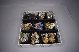 A tray containing a selection of clip earrings and brooches including Monet & Pilgrim