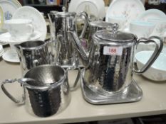 A Old Hall hammered finish stainless steel breakfast set including sugar basin, tray,jug and more.