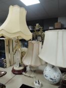 Three table lamps with shades.