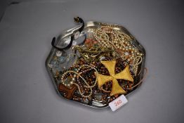 A small selection of costume jewellery including wrist watches, gold plated chains, strings of beads