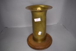A vintage military ammunition shell on wooden base