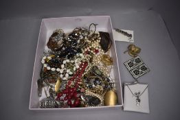 A small jewellery box containing fashion necklaces brooches and bracelet