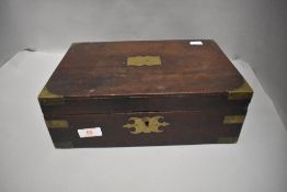An antique vanity case having mahogany body with brass banding and flip out mirror