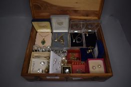 A treen box of costume jewellery and pendants necklaces and earrings