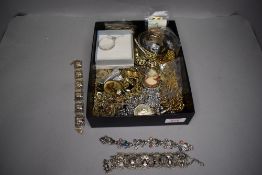 A selection of gold plated and silver plated jewellery including magnifying glass pendants, bangles