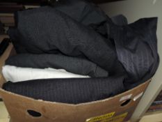 A box full of gents modern and retro suit jackets and trousers.