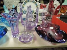 A collection of art glass bowls,vases and a paper weight in lilac hues.