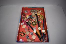 A selection of costume jewellery including brooches, watches and necklaces etc