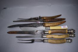 A selection of horn handled carving knives and forks having HM silver collars