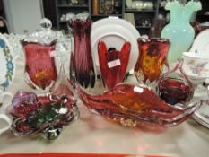 A collection of art glass bowls,vases and a paper weight in red hues.