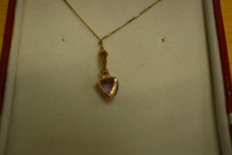 A 9ct gold pendant having amethyst and cubic zirconia decoration on a yellow metal chain stamped