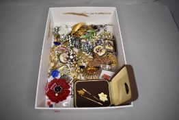 A selection of costume jewellery including brooches and enamel badges
