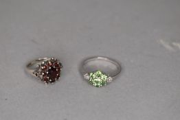 A garnet cluster dress ring in a moulded decorative mount on a silver loop, size L & a peridot style