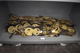 A selection of various horse display brasses on leather straps