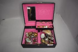 A jewellery box containing a variety of costume rings