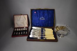 A selection of silver plate including cased spoons and salt pig