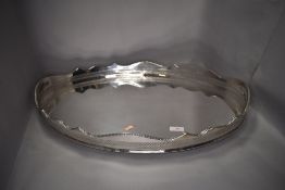 A large butlers serving tray having gallery sides and twin handle