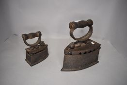 Two cast metal stove top irons