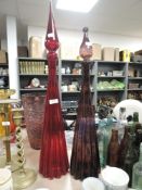 Two impressive apothecary our chemists style vessels, one red the other purple.