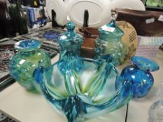 A selection of teal and green art glass including bowls and jars.