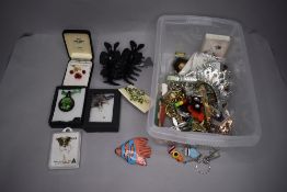 A selection of costume brooches and glass pendants etc