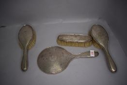 A Hm silver dressing table set having machine tooled backs