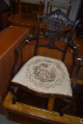 An Edwardian mahogany armchair having shaped back