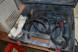 A cased Bosch hammer drill