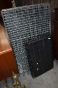 A large dog or animal crate and a similar smaller sized crate