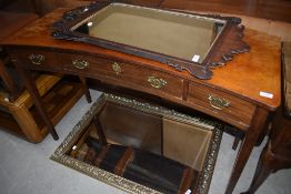 A 19th Century side table of interesting concave form in mixed woods