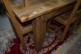 A modern rustic wood kitchen table having rectangular top on heavy square legs, w 152