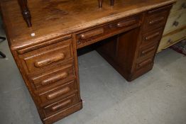 An early 20th Century oak pedestal desk