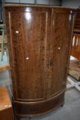 A hallway or similar wardrobe having curved front with drawer base