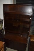 A vintage style dark stained and smoked glass lounge unit , nice size at just 100cm wide