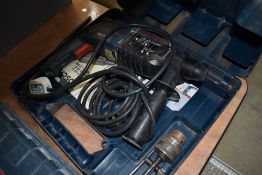 A cased Bosch hammer drill