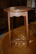 An early 20th century golden oak occasional table having circular top and slender legs, w 36cm