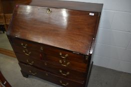 A Georgian mahogany bureau having oak fitted interior