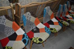 A set of 6 modern dining chairs having multi coloured upholstery on rubber wood supports