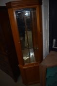 A modern corner display in teak with mirror back and glass shelves to top section, cupboard under